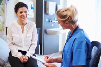 Female Patient And Doctor Have Consultation In Hospital Room | CU Medicine OB-GYN East Denver (Rocky Mountain)