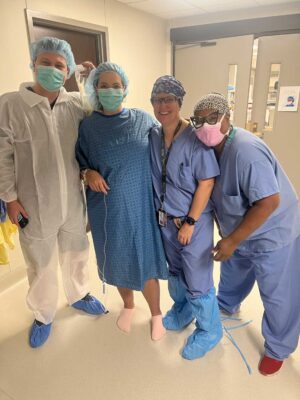 : Bobby, Sara, Dr. Schneider and Wynedra standing in the hospital hallway | CU Medicine OB-GYN East Denver