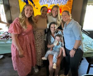 Micah on his first birthday and mom Sarah pose with the East Denver OB-GYN medical team