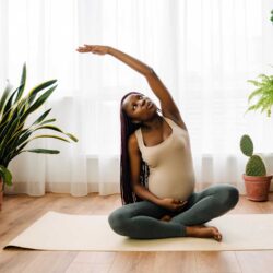 Peripartum woman stretches after discussing her exercise and physical therapy concerns with her OB-GYN | CU Medicine OB-GYN East Denver