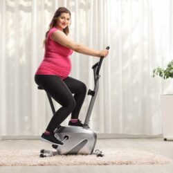 Pregnant woman uses stationary bike after discussing her exercise concerns with her OB-GYN | CU Medicine OB-GYN East Denver