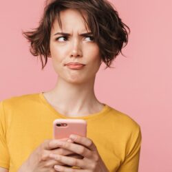 Woman with smartphone in her hands with a confused look about birth control myths | CU Medicine OB-GYN East Denver (Rocky Mountain) | Denver